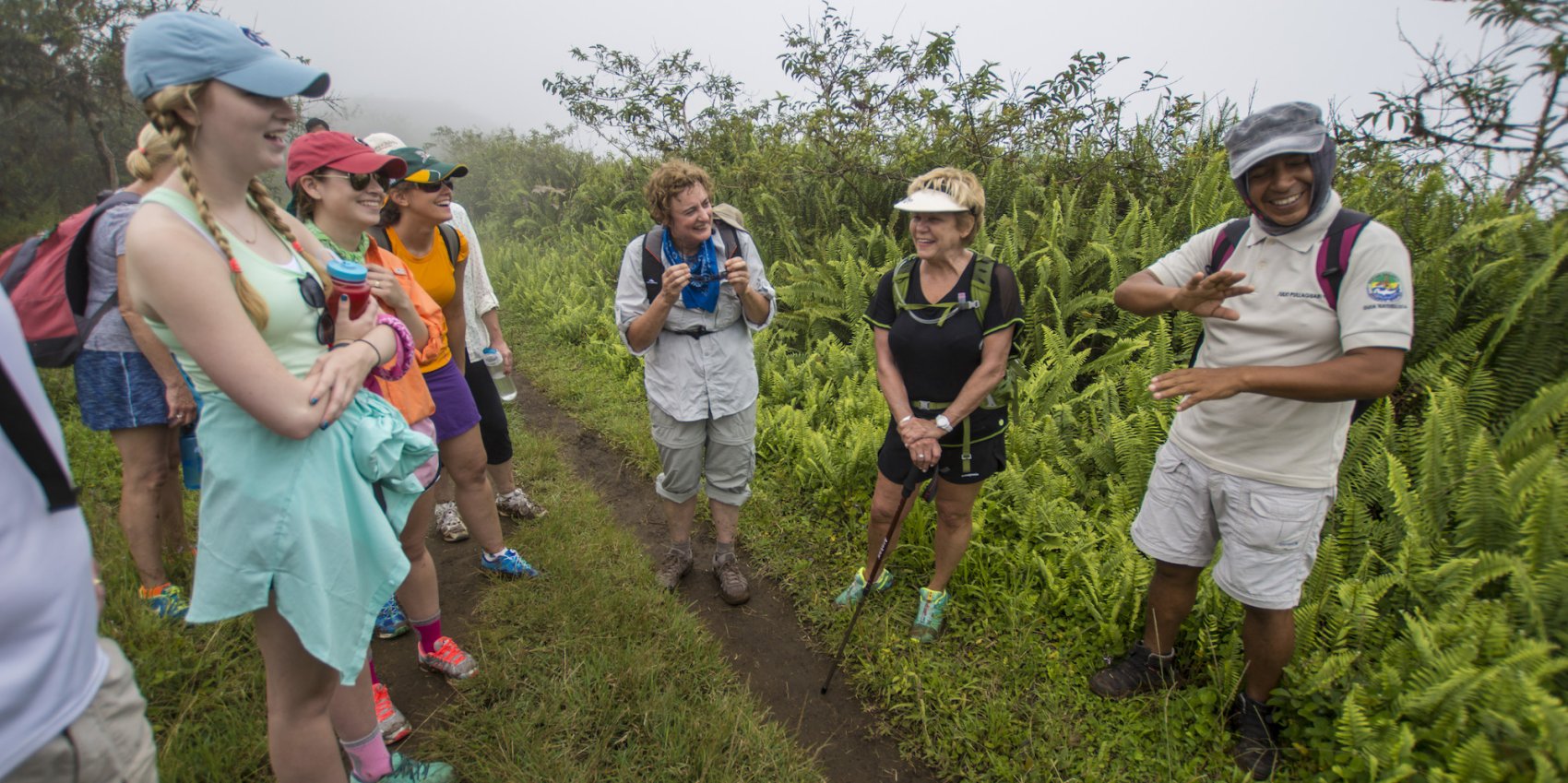 A group of tourists on a hike with an Ecuadorian guide in the Galapagos Islands