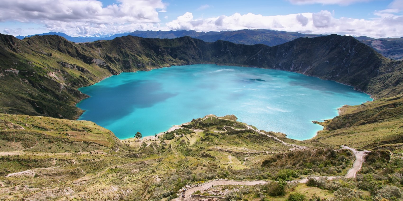 Aerial view of Quilotoa Crater Lake and surrounding Ecuadorian Andes – a scenic stop after Galápagos travel.