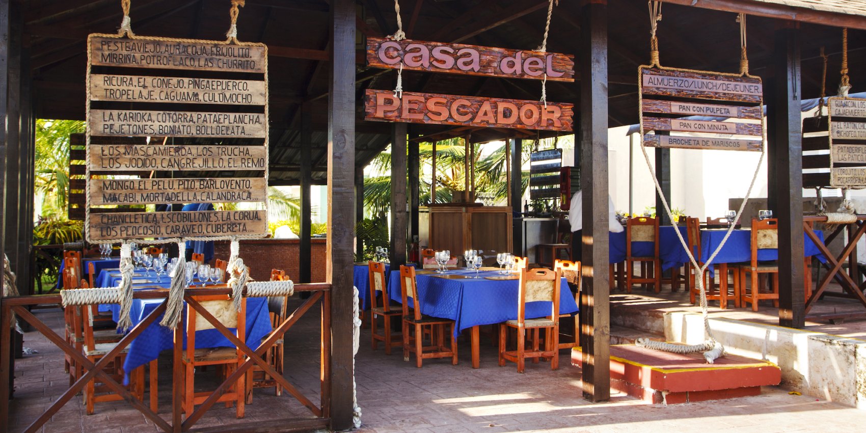 View of the entrance and empty outdoor seating at a restaurant in Cuba