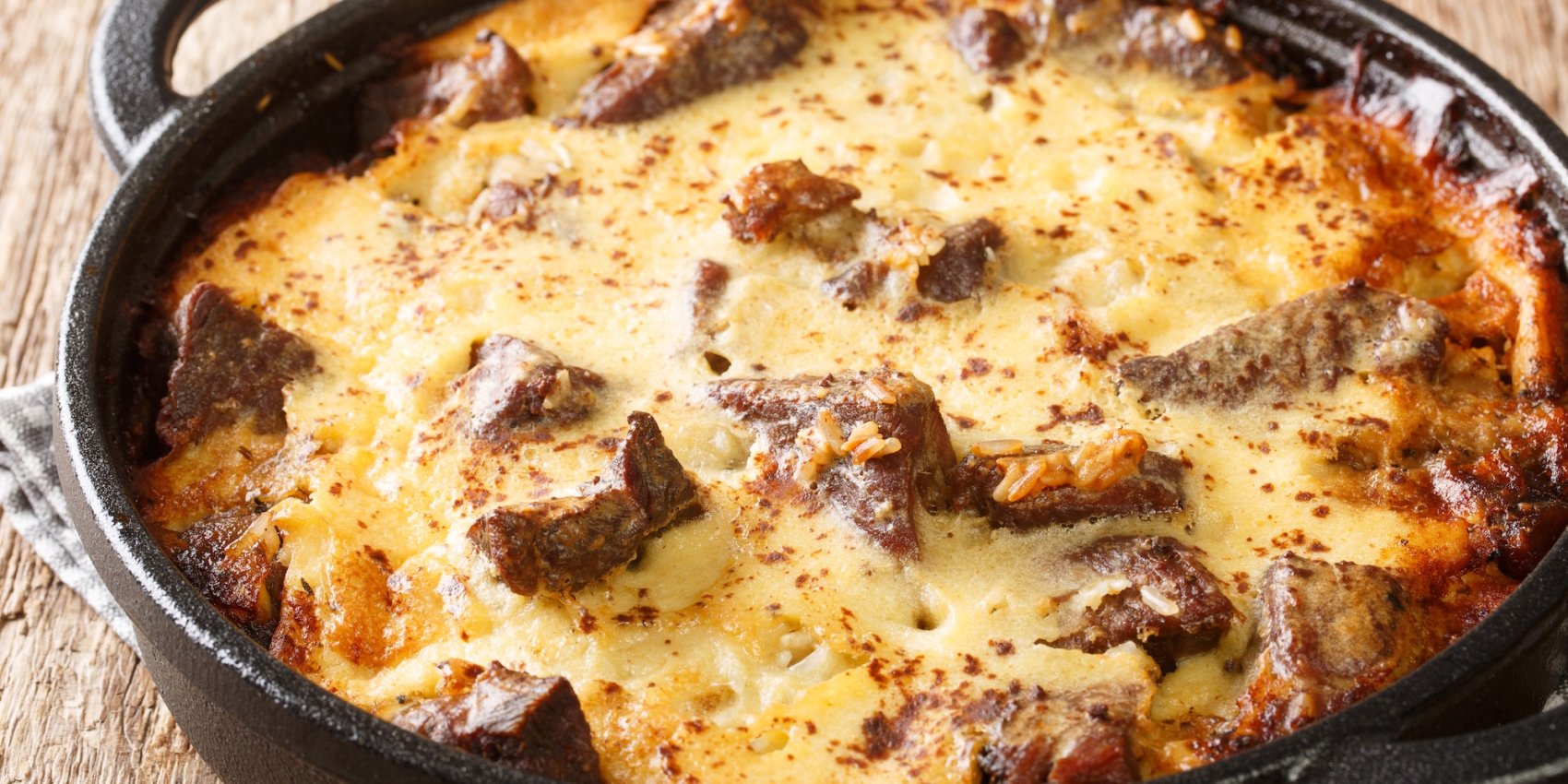 Albanias national dish Tavë Kosi in a cast iron dish.