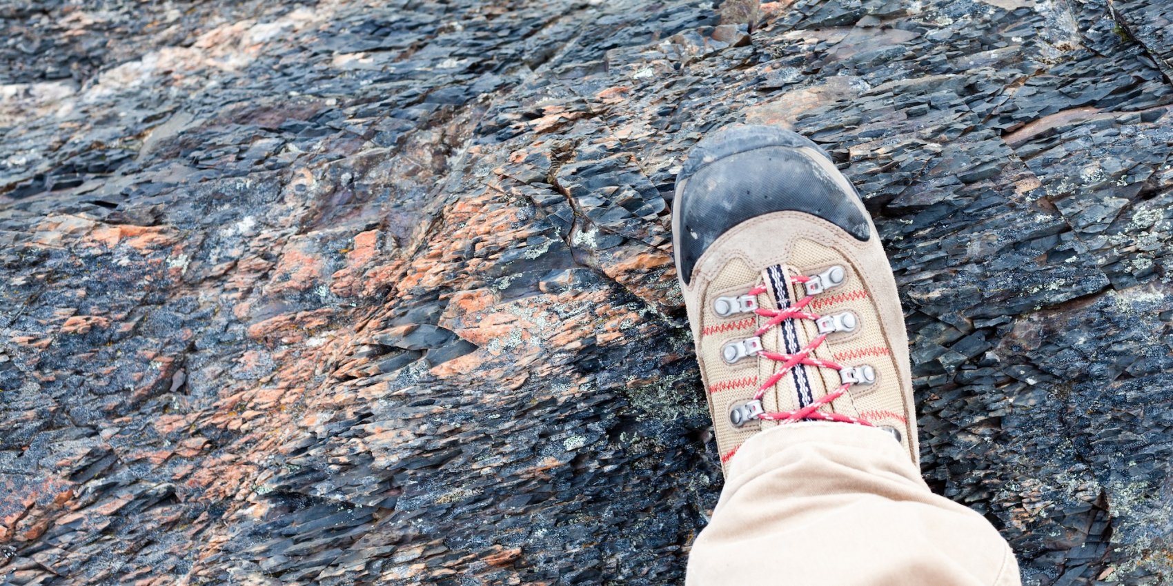A hiking boot on volcanic rock in Portugal