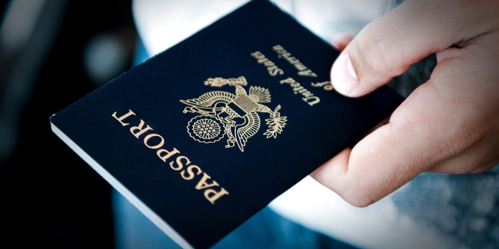 A person holding out their passport.