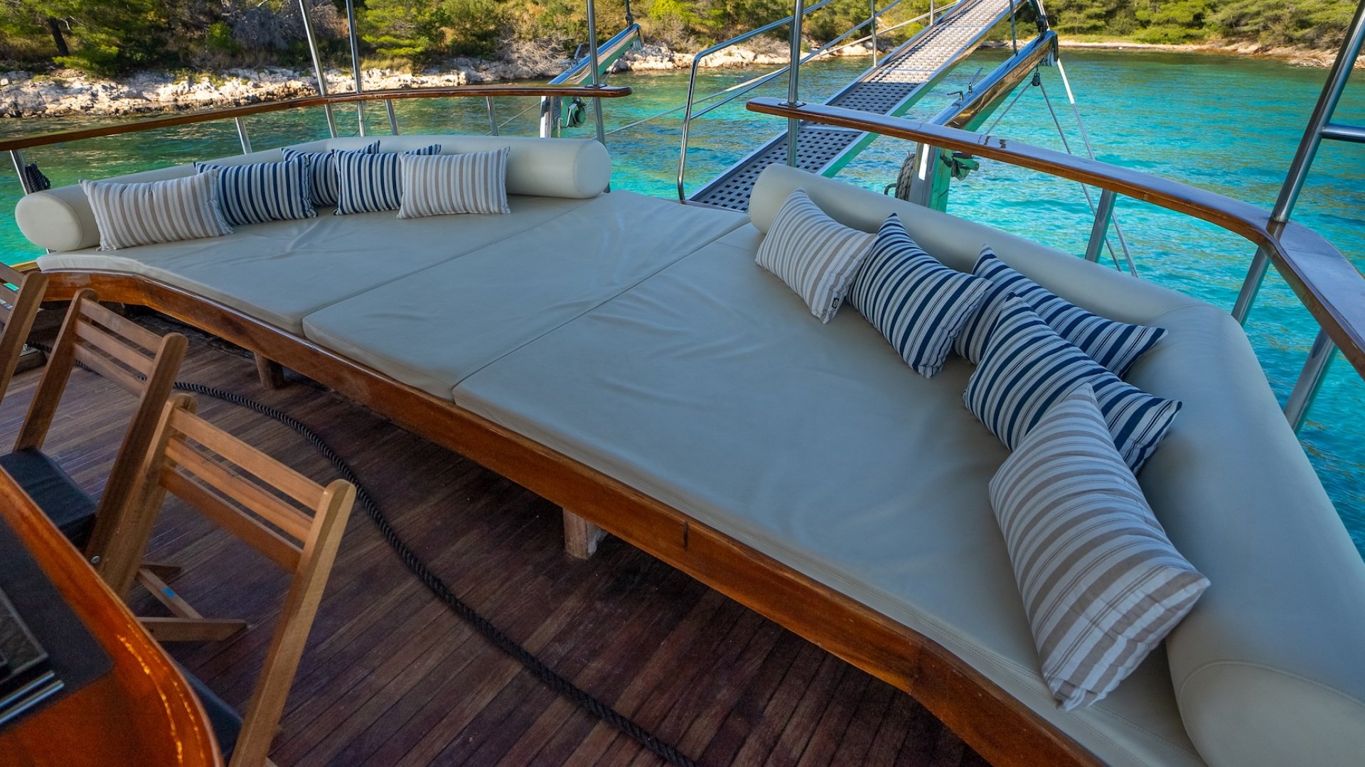 The back deck cushioned lounge area on a yacht sailing off of the shores of Croatia.