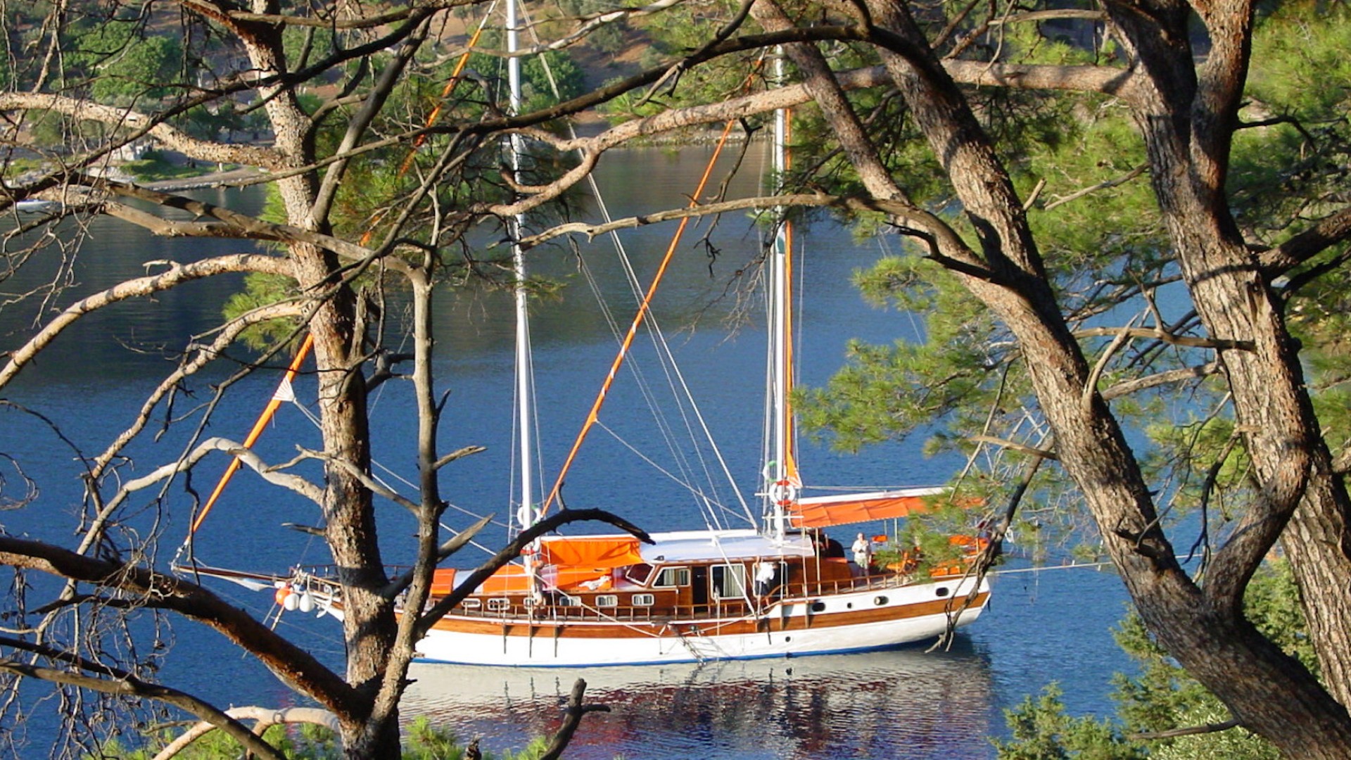 View of a yacht in the water in Turkey taken from a hike on a nearby hillside