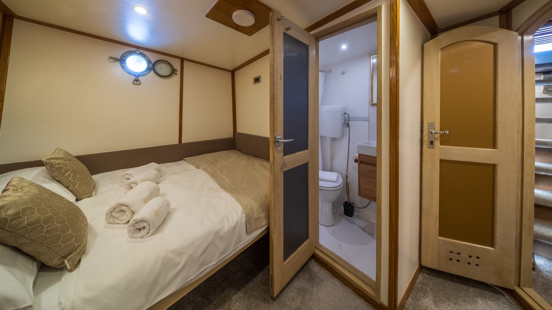 A cozy yacht cabin with a private ensuite bathroom.