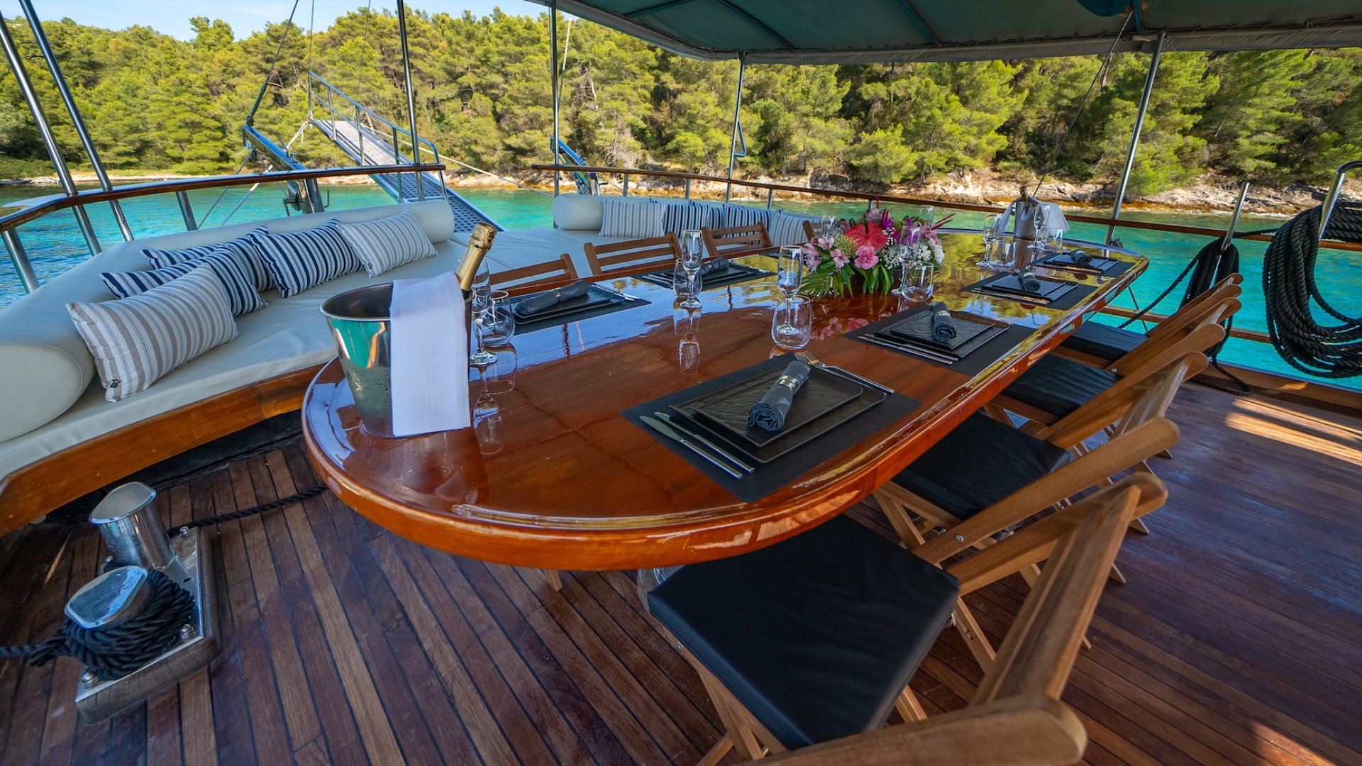 Outdoor dining area at the stern of a luxury yacht sailing in Croatia.