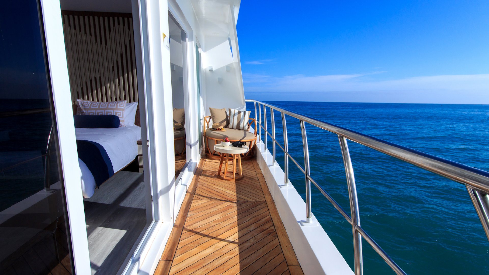 Private balcony off of a room aboard a small ship in the sun