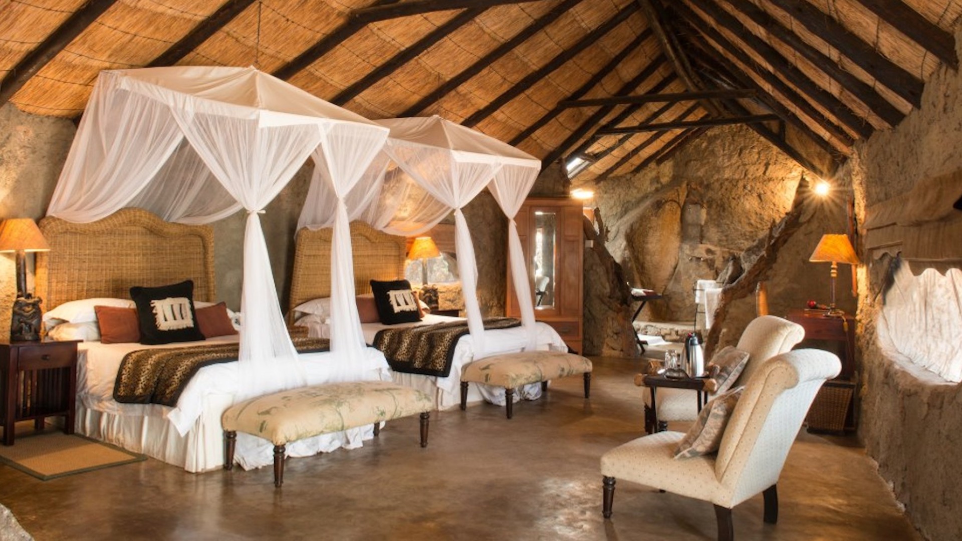 Cement room with two double beds at a safari lodge in Zimbabwe