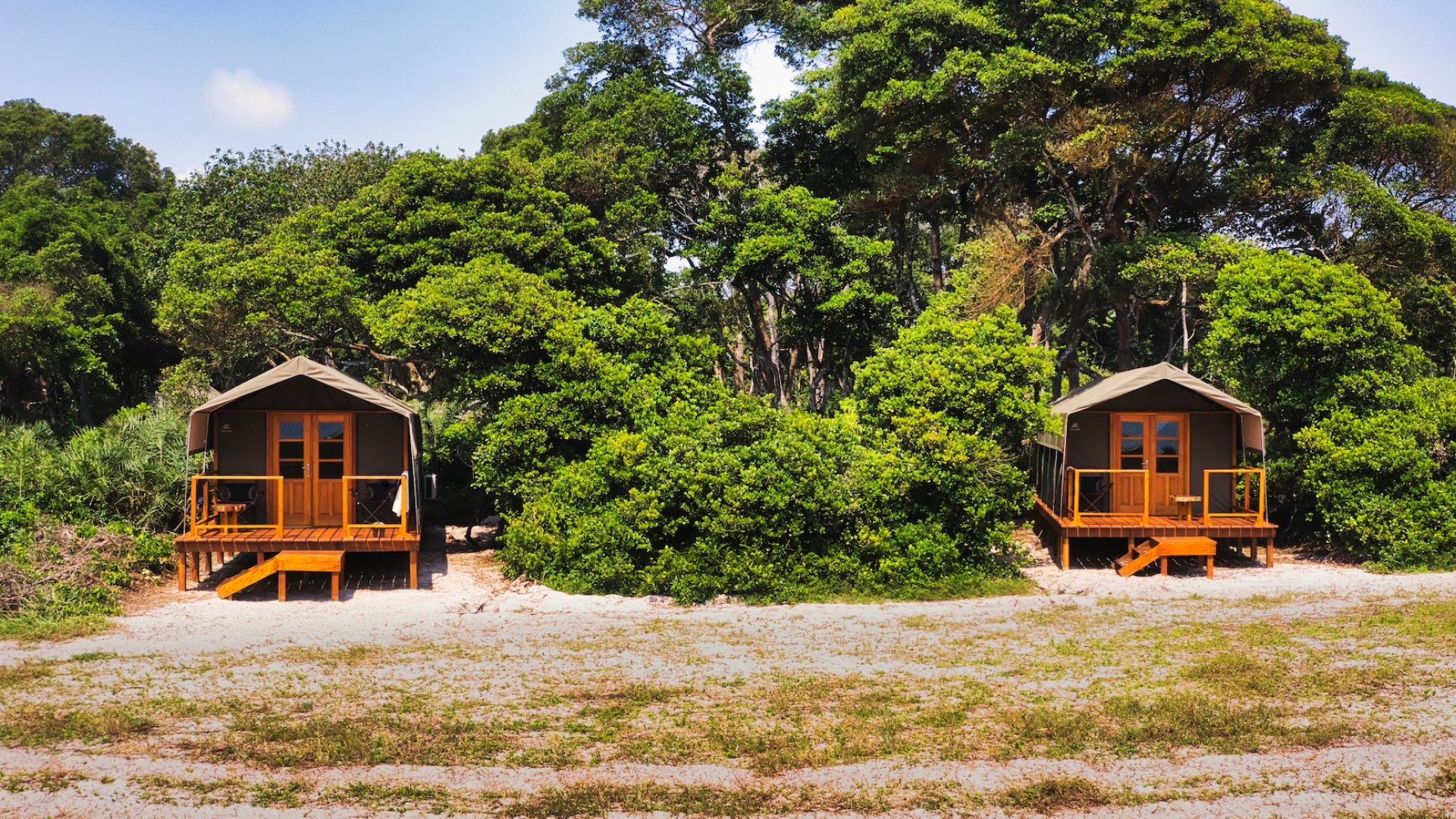 Two raised chalet lodges amongst the trees in Gabon