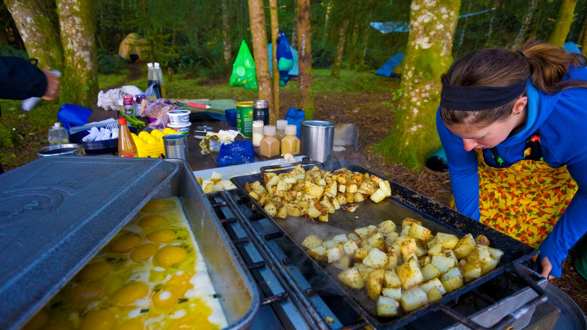 Breakfast potatoes cooking on a large skillet while camping on an island in BC