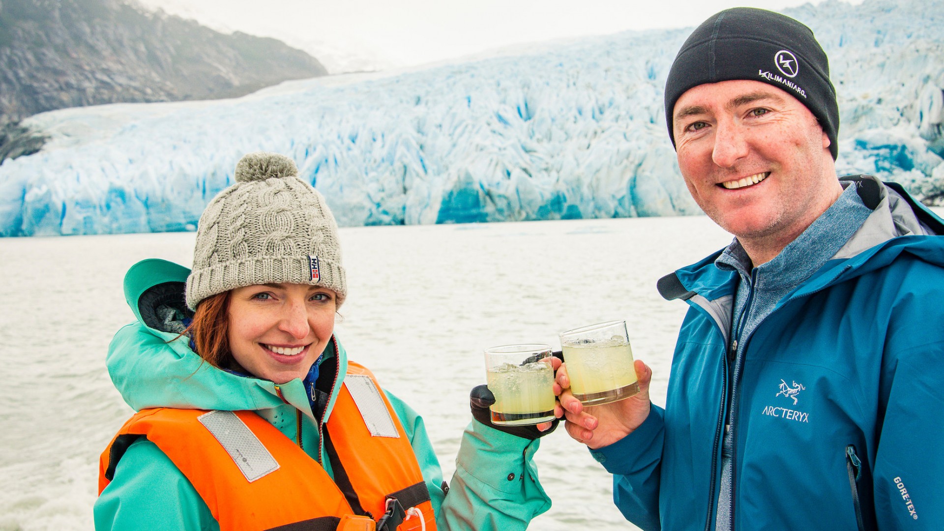 couple drinking during iceberg tour in patagonia