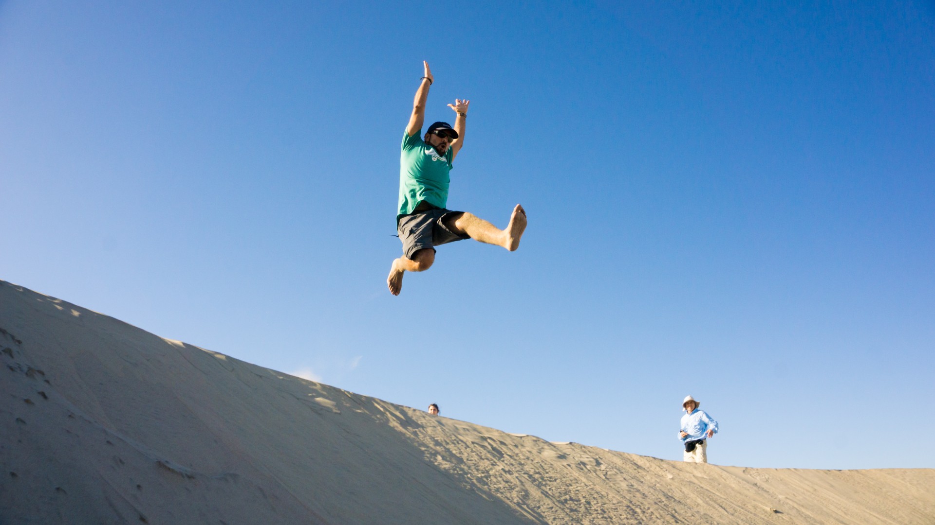 Person running through the sand dunes of Magdalena Bay in Baja California Sur, Mexico