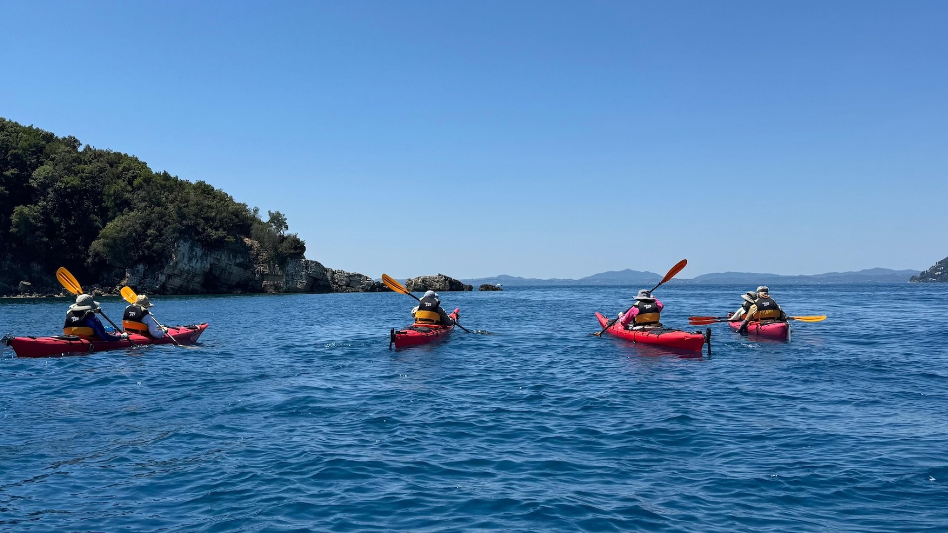 Sea kayakers paddling along the shores of Croatia