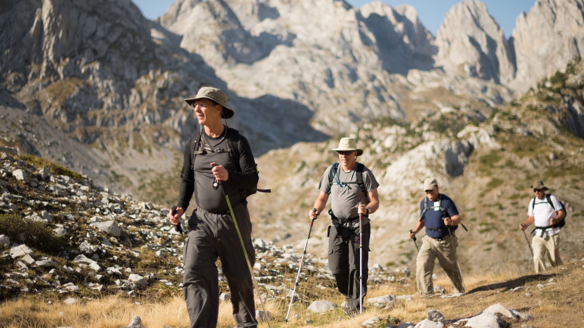 Group of hikers trekking through the rugged mountains of northern Albania during a guided Albania hiking tour, part of an unforgettable Europe hiking tour experience.