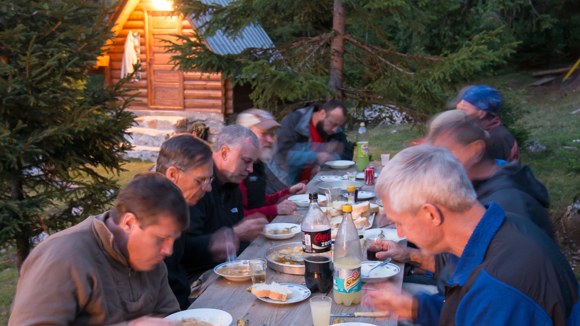 Group eating dinner at a picnic table in Albania