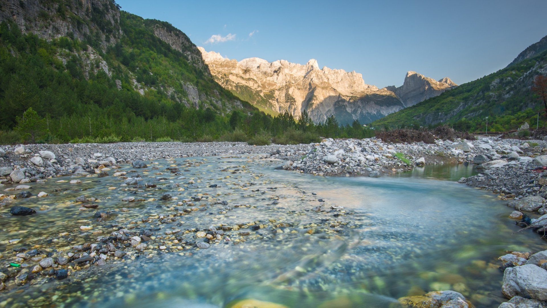 Scenic river flowing through a mountain valley in Albania, surrounded by dramatic peaks and lush forest—an iconic stop on an Albania hiking and Europe hiking tour.