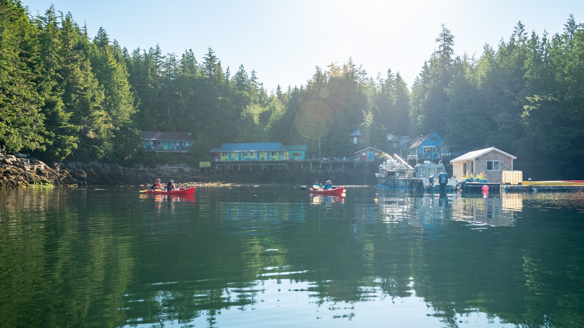 Sea kayakers paddling near God’s Pocket Resort in the sheltered waters of British Columbia