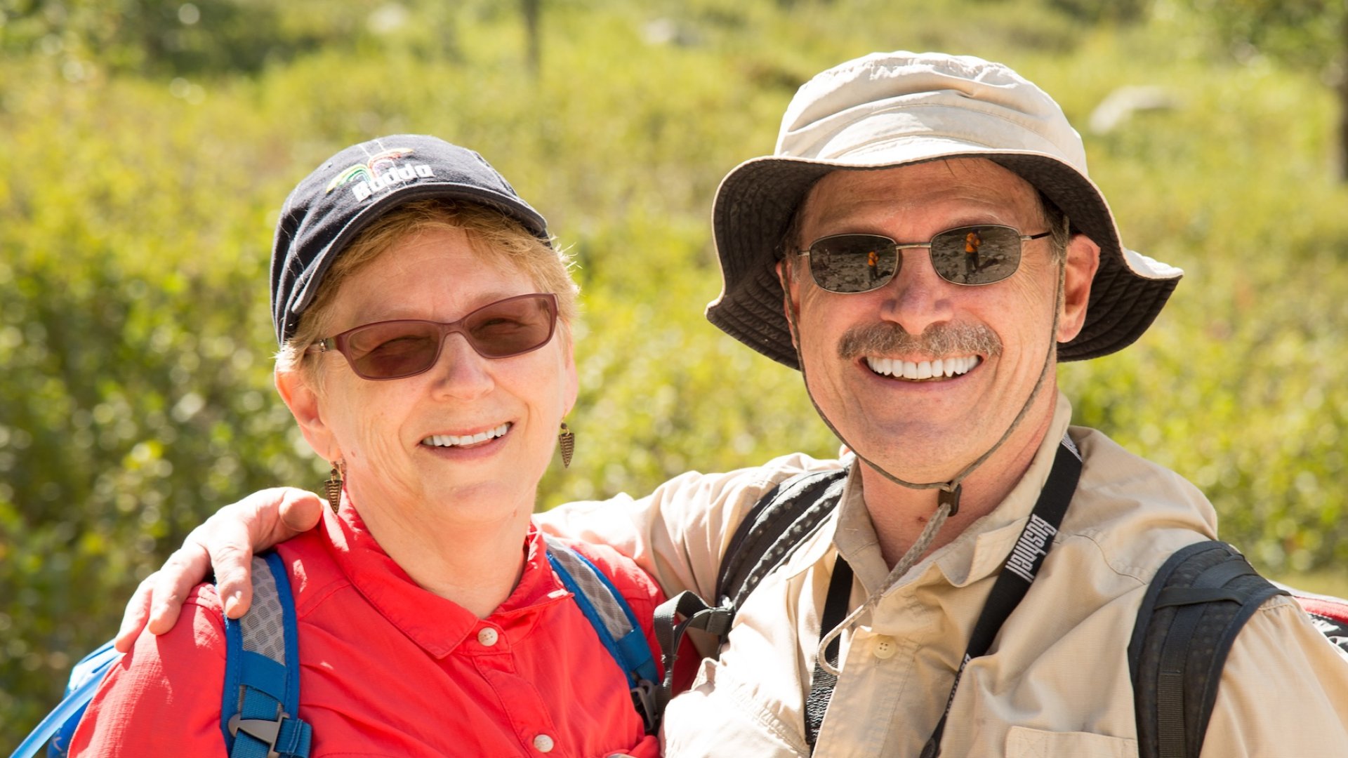 Smiling hikers enjoying a sunny day of hiking on Corsica during a guided adventure tour.