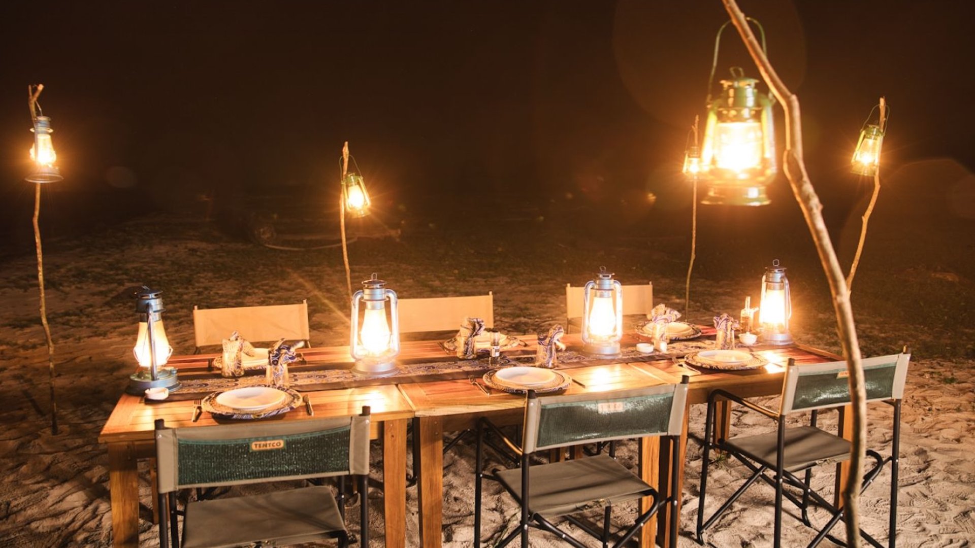 A table set up outside for an outdoor dinner. 