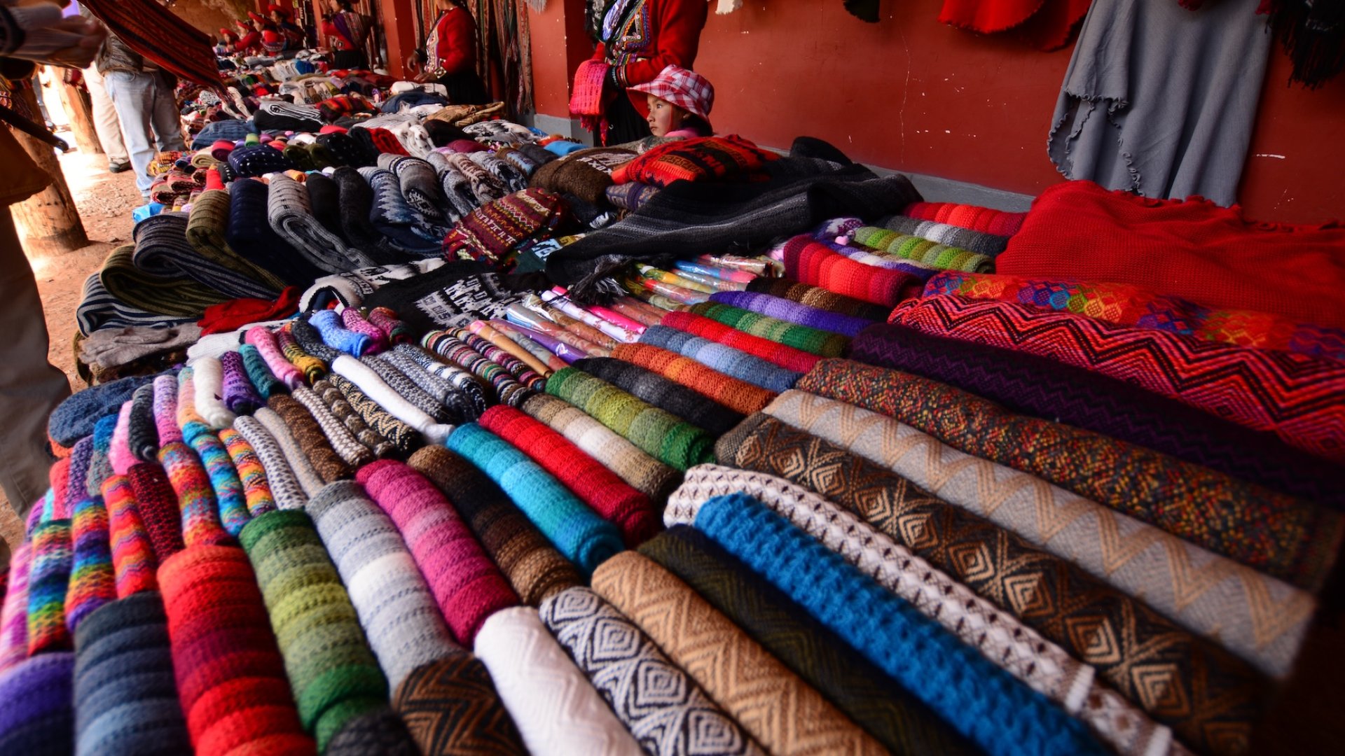 Traditional Peruvian market with colorful textiles and handwoven fabrics – Peru travel cultural experience