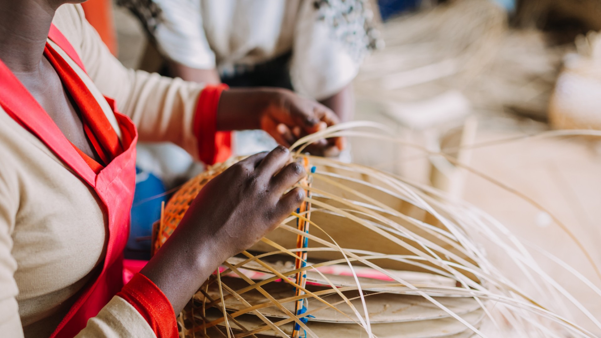 Woman practicing traditional basket weaving in a small town in Rwanda