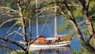 View of a yacht in the water in Turkey taken from a hike on a nearby hillside