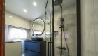 Modern style bathroom inside of luxury Croatian yacht with a round mirror and shower.