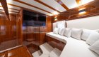 Interior cabin on a yacht with a lounge area and TV.