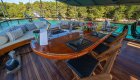 Outdoor dining area at the stern of a luxury yacht sailing in Croatia.