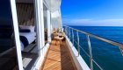 Private balcony off of a room aboard a small ship in the sun