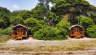Two raised chalet lodges amongst the trees in Gabon