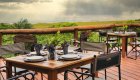 A couple of tables and chairs set for dinner overlooking views of the Gabon wilderness.
