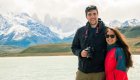 A couple smiling in front of Torres del Paines while on a package tour of Patagonia