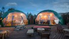 Two geodesic domes on top of a wooden porch in Patagonia