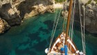 Top down view of a small ship above crystal clear turquoise waters in Croatia
