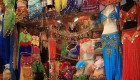 Colorful booth at a Turkish market full of traditional and elaborate clothing 