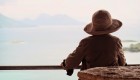 Woman wearing a sun hat overlooking the sea from the side deck on the Romanca ship