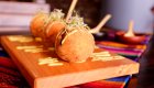 Traditional Peruvian food served on a wooden platter with colorful textiles – culinary travel in Peru