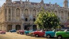 classic cars lined up on street in cuba