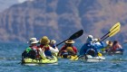 Group of kayakers form behind paddling towards Danzante Island in Loreto Bay, Mexico