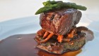 A juicy steak on top of mushrooms with asparagus on top