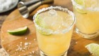 Margarita on the rocks with salt and lime on a cutting board 