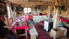 Rustic accommodations with bunk beds in Albania built with wood and decorated with a string of flags 