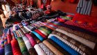 Traditional Peruvian market with colorful textiles and handwoven fabrics – Peru travel cultural experience